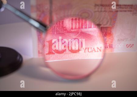 Closeup of chinese currency: Renminbi (RMB).The People`s Bank of China 100 yuan currency, economy, RMB, finance, investment, interest rate Stock Photo